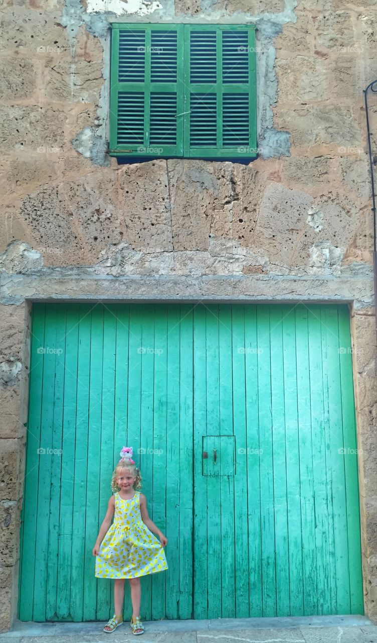 Portrait of a girl standing on closed door
