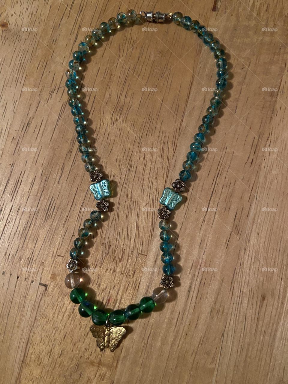 Butterfly necklace I made with beads from the craft’s store and a gold charm. 