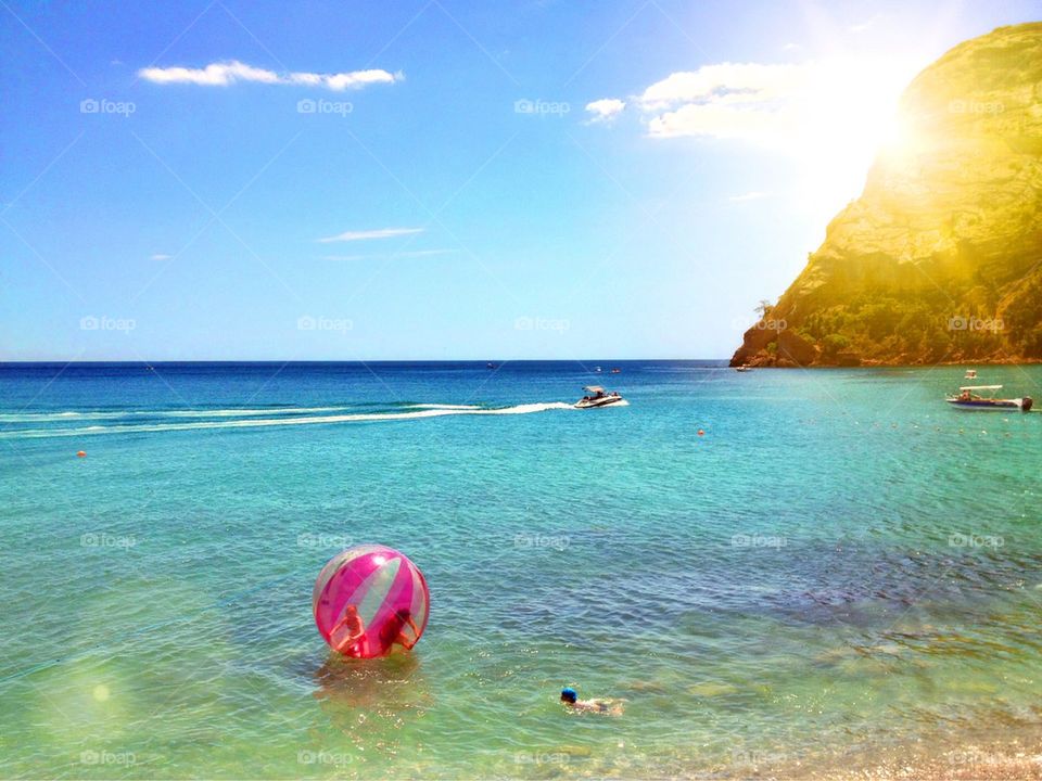 Tourist inside the large pink ball floating on sea