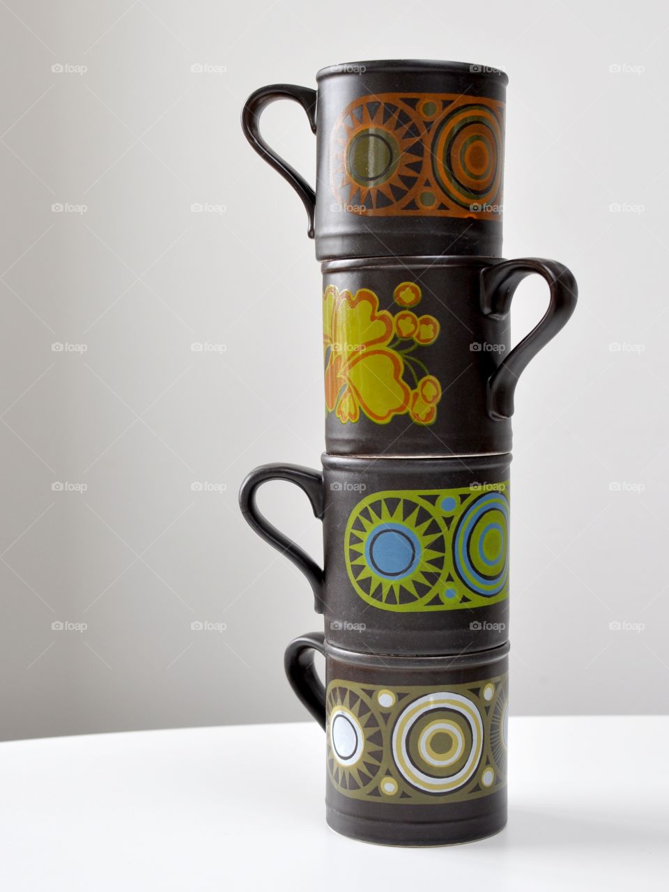 Four retro mugs stacked on top of each other (Staffordshire)