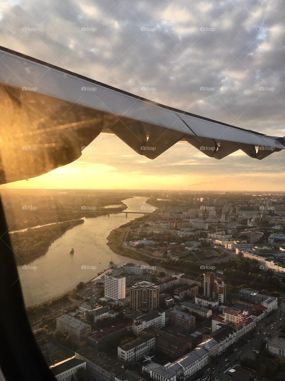 City view from the airplane window, river in the city 