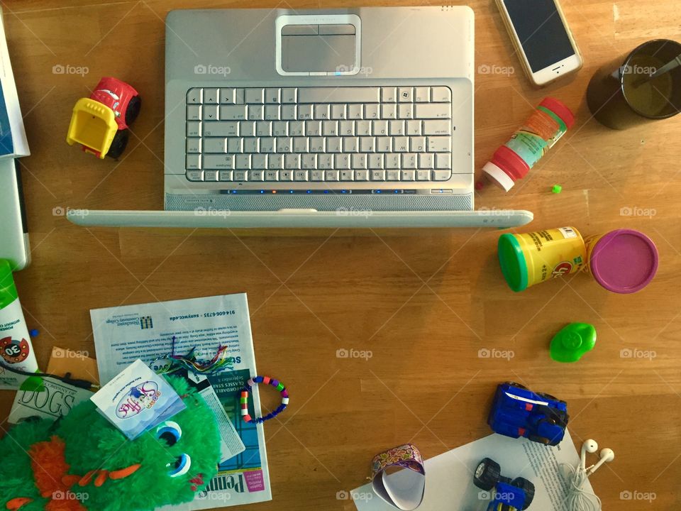 Mom entrepreneur. The desk/kitchen table of a mother who works at home