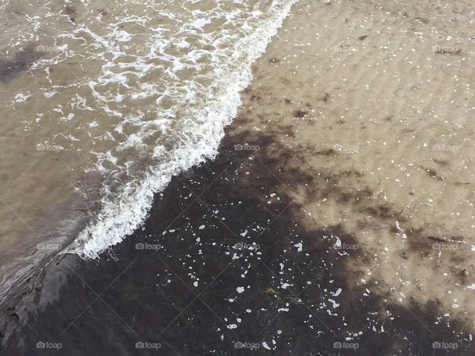 Wave on beach from above