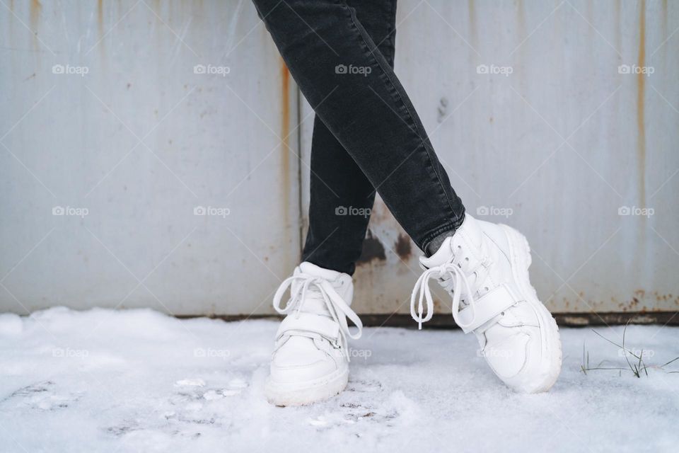 Young woman in white Dr. Martens boots in winter 