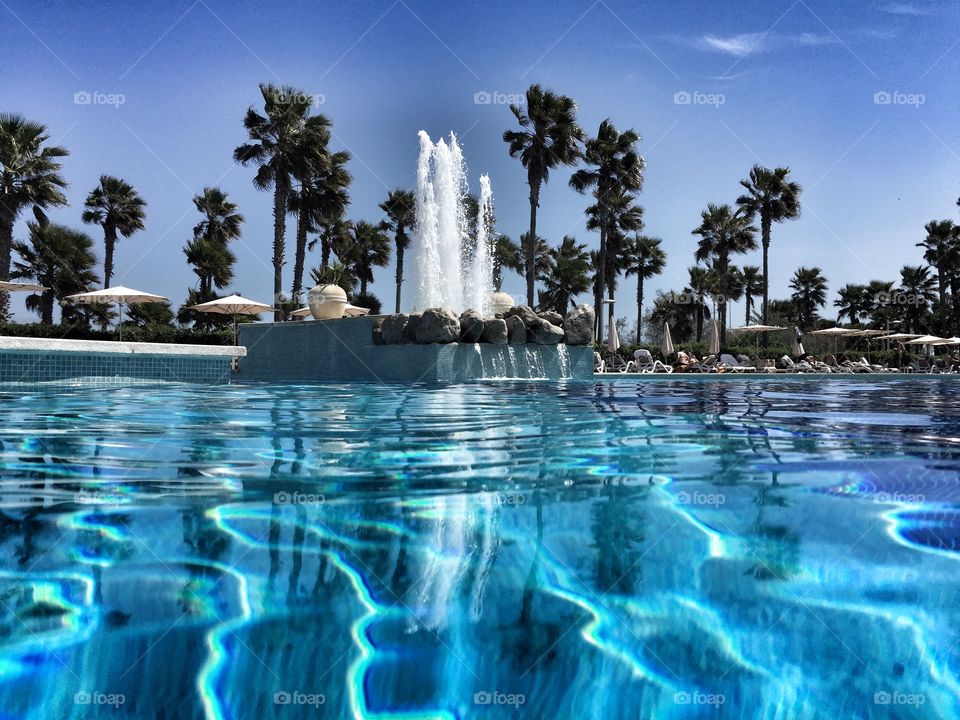 Poolside. Swimming pool with fountain in Majorca, Spain