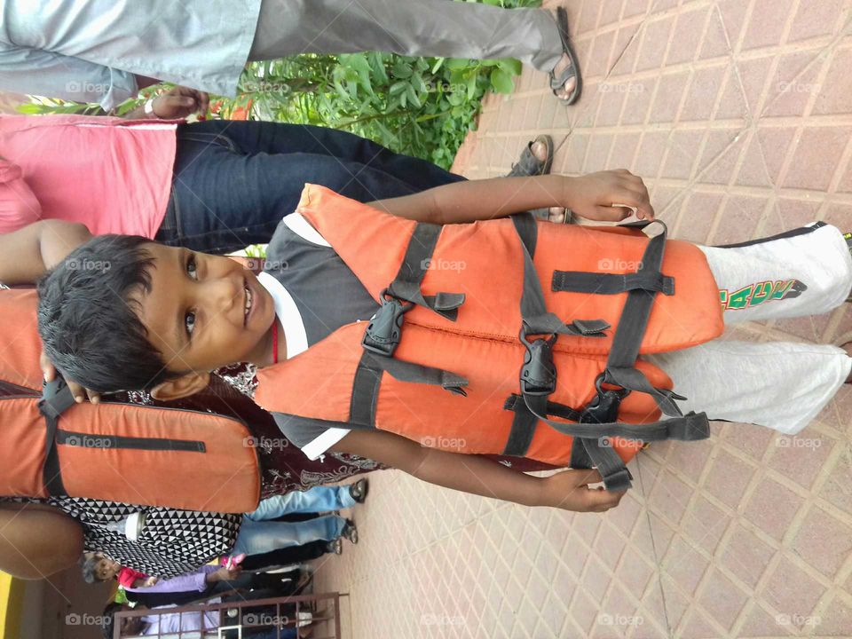 Kid ready to go boating on sea.