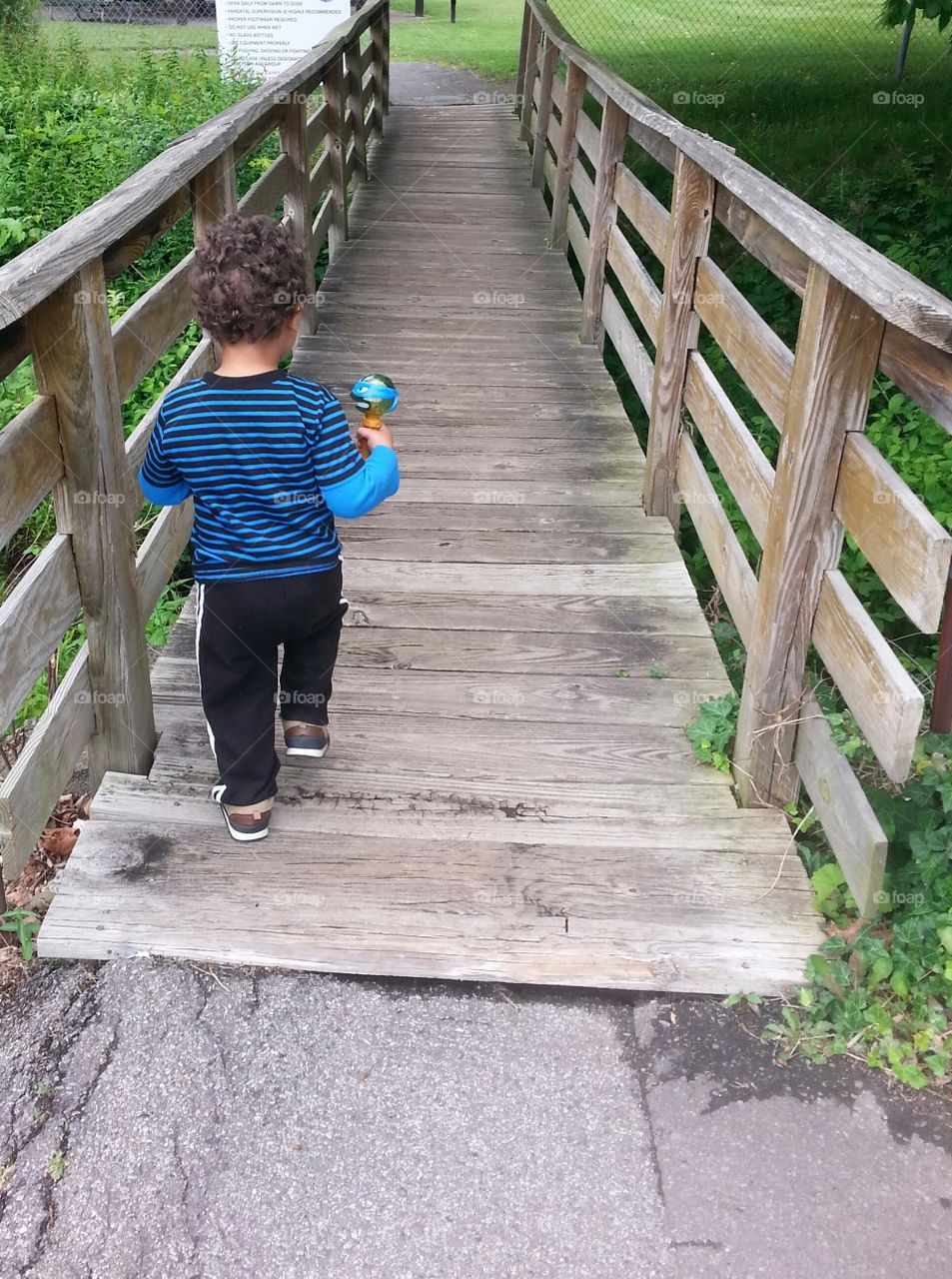 Small steps. walking over bridge at park