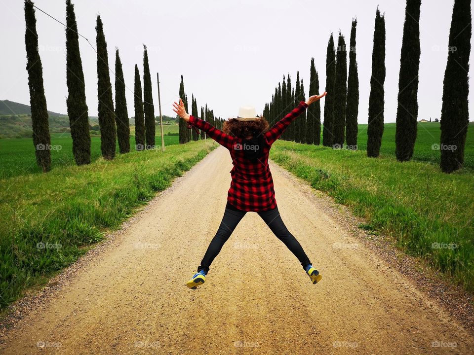 Woman jumps on the street in a moment of joy and fun