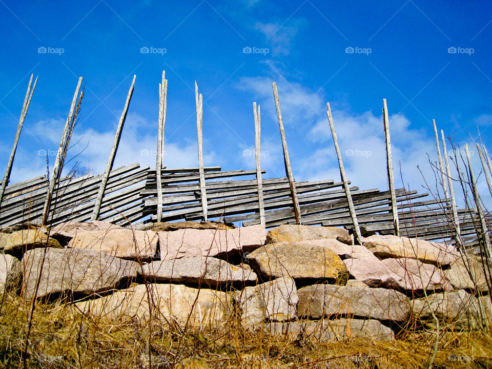 Wooden fence on stone wall