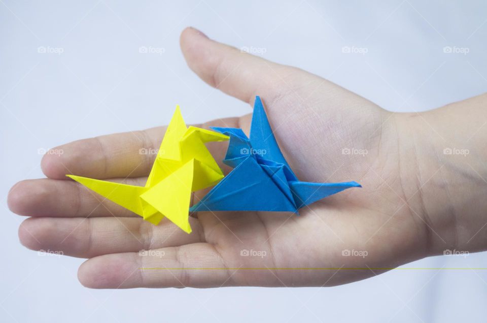 The child holds the origami cheering