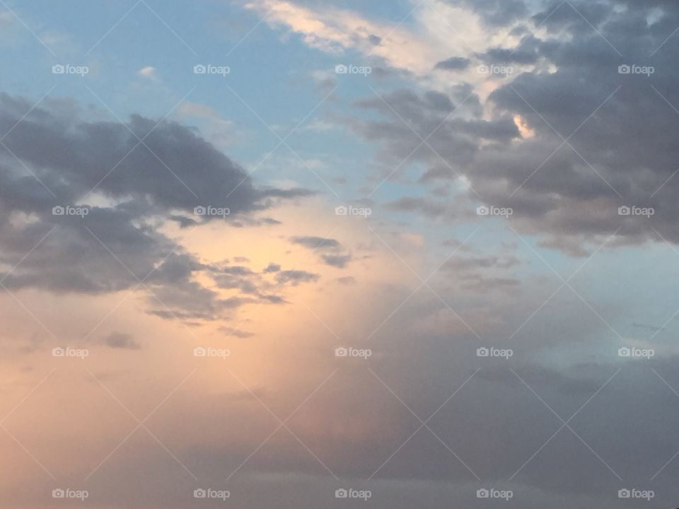 Glowing sky behind storm clouds 