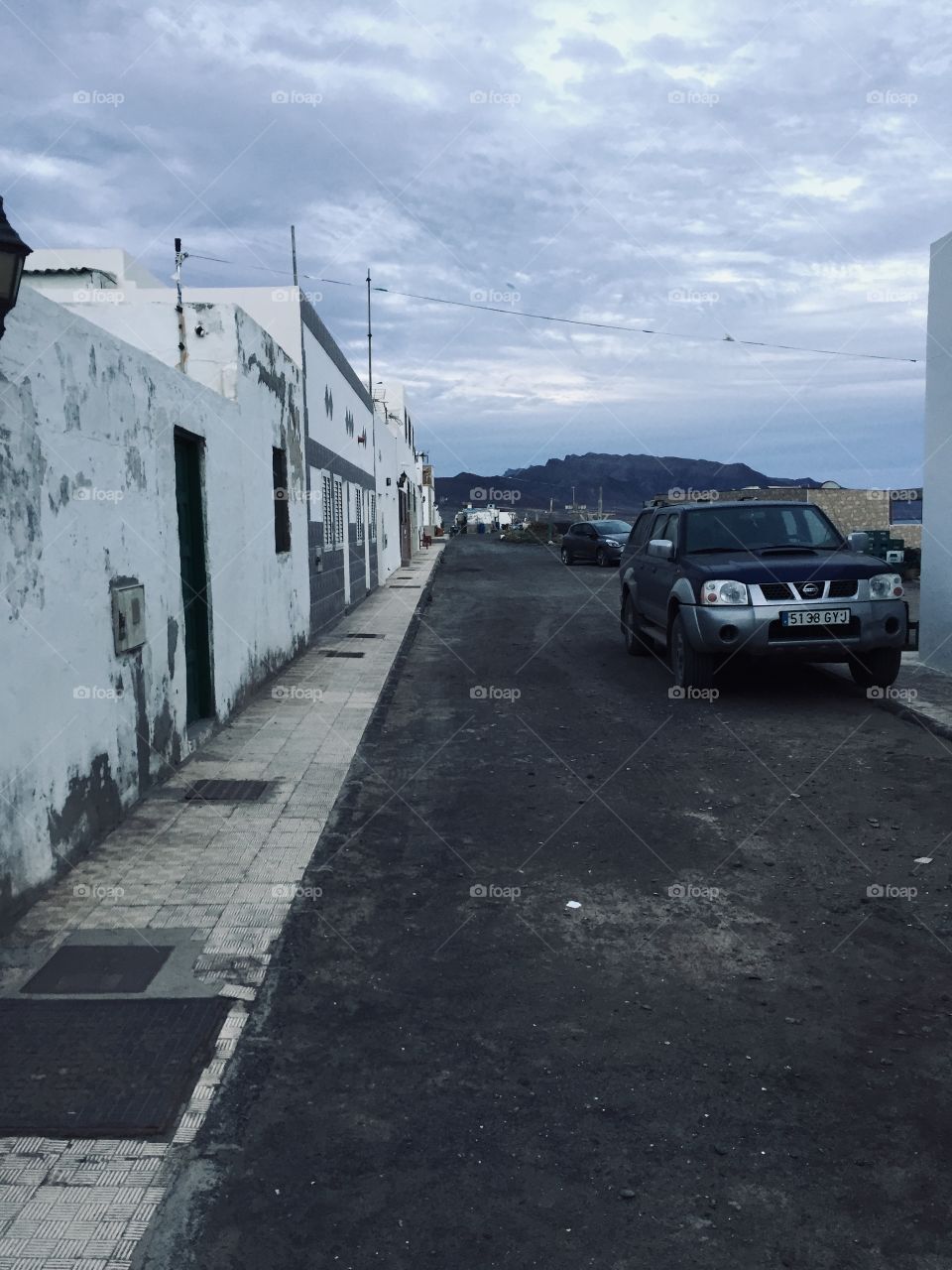 Rustic desert street with car