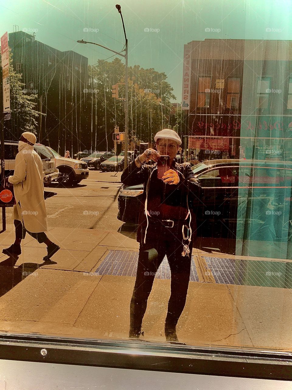 Reflection of myself, the photographer while taking this picture in a specially treated large store front window so it gave off a reasonably clear image of whatever was reflecting in it. Found on Fulton Street in Brooklyn, NY in the summer of 2020.