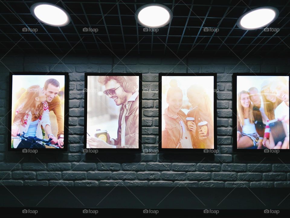 promotional photos on a gray wall