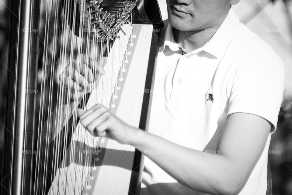 Man is playing an harp