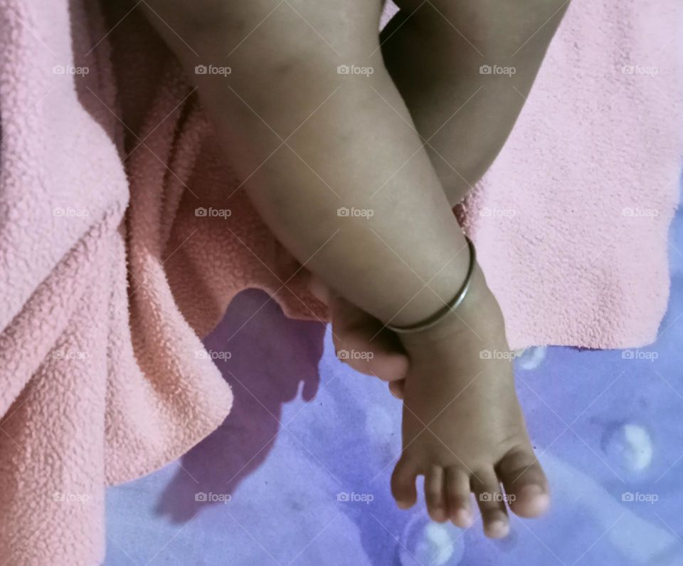 This beautiful ❤️😍 legs 🦵 of two months baby girl 🐥😍. Baby is sleeping in her bed and playing joyfully with her toys!!🪀🧸