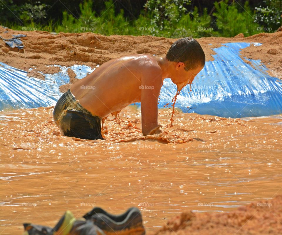 Caught in motion - Water and mud dripping from a contestant in the annual Mud Run - Some of the best and most memorable moments in life are in motion.