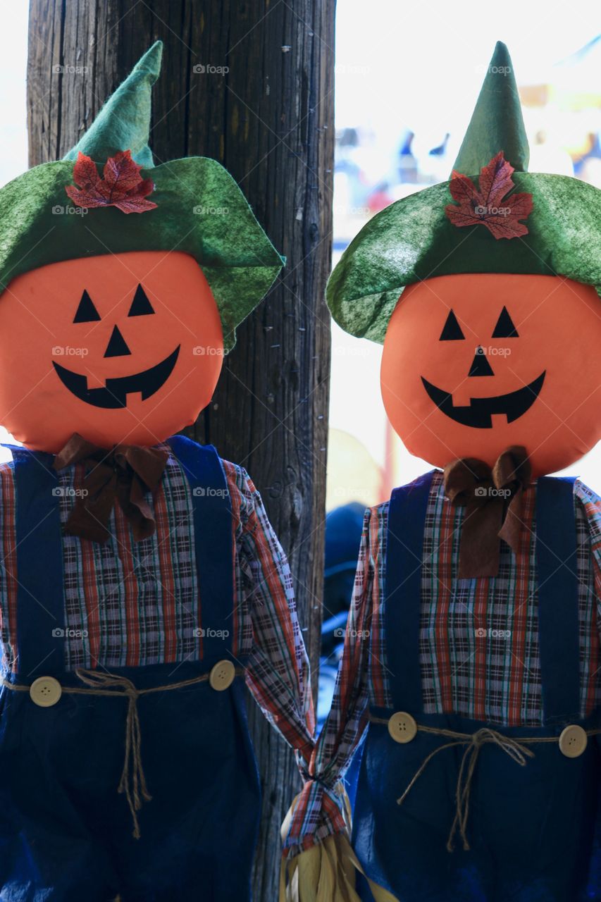 Two pumpkin head scarecrows 