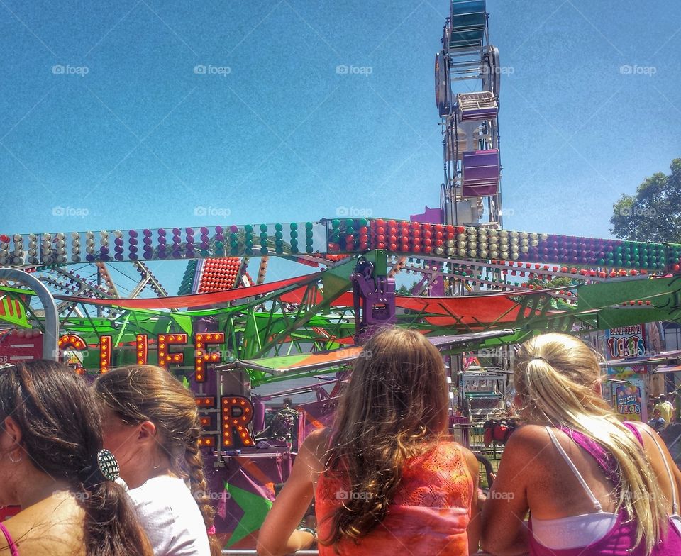 Fun at the County Fair. Girls Enjoying the Amusement Park