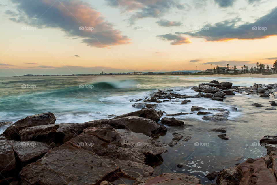 Beach waves and rocks during sunset in Wollongong, NSW, Australia