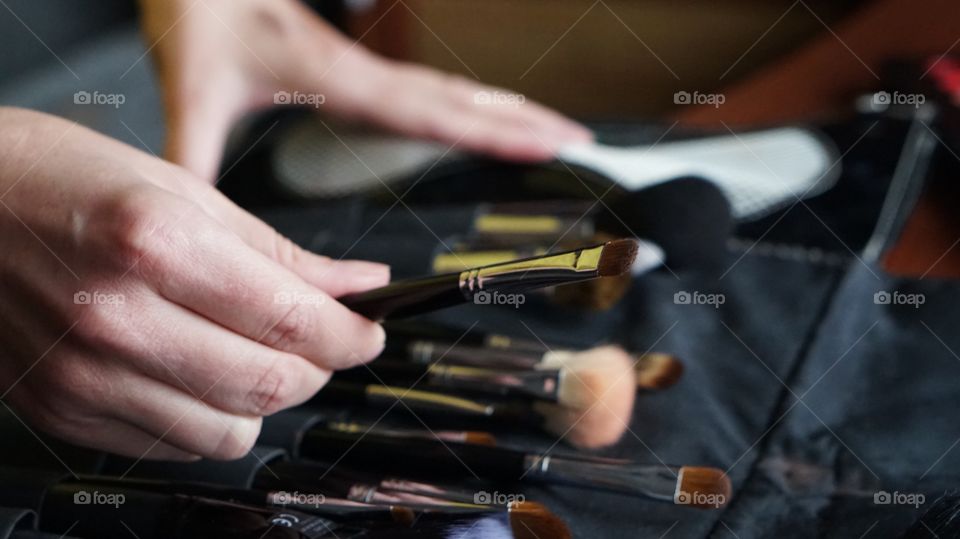 Close-up of person hand holding make-up brush