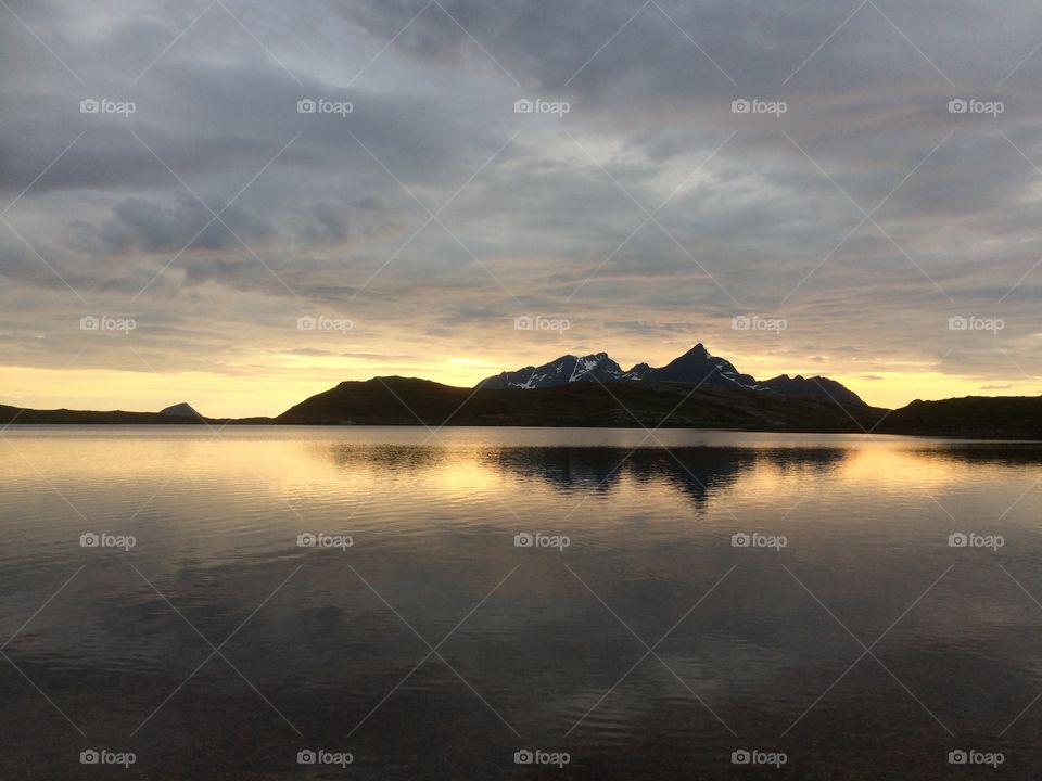 Sunset in the Norwegian mountains and reflection to the lake