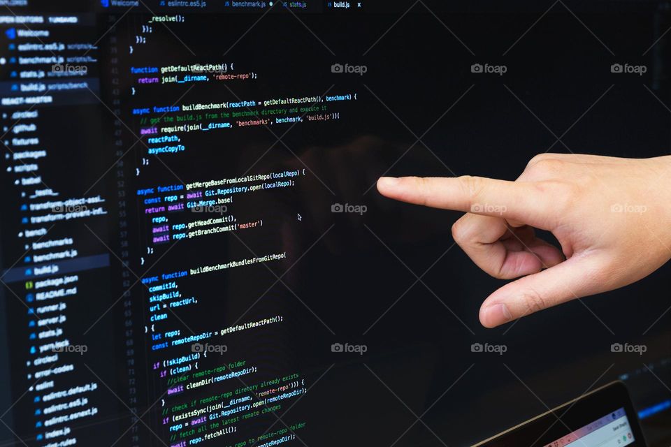 Finger Pointing At Javascript Code Photo

A Developer points to the Javascript code in their IDE.