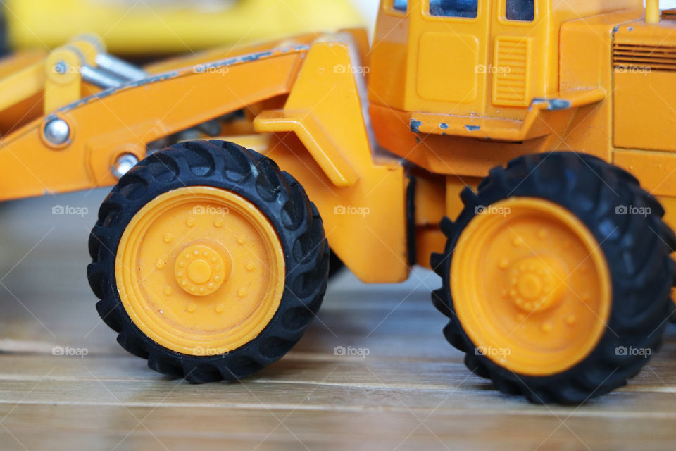 Large orange tires on a toy truck