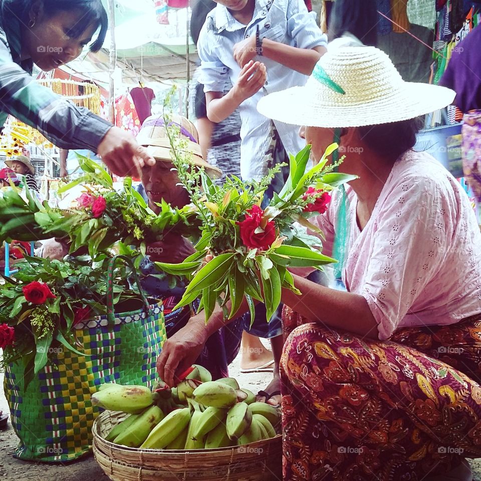 Exploring Myanmar,  women selling flowers on the festival
