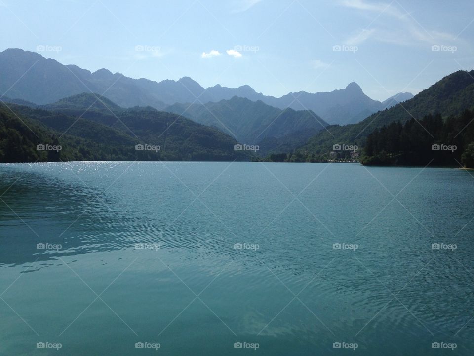 Scenic view of lake near green mountains