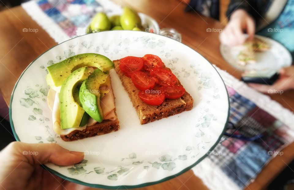 Avacado turkey tomato sandwich on wheat bread