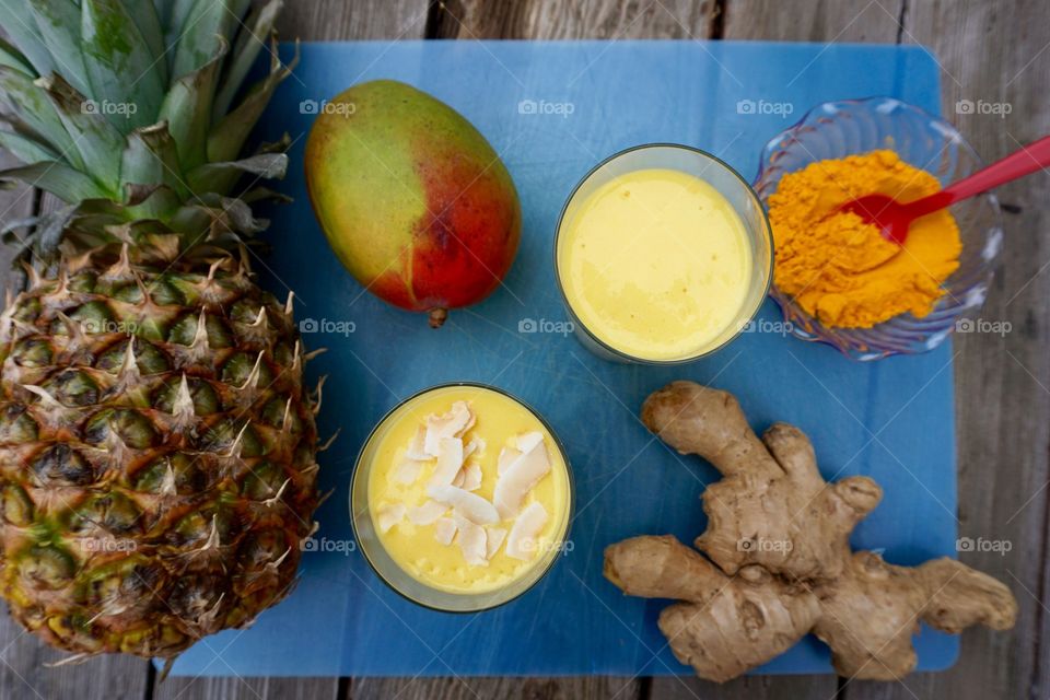  Overhead view mango pineapple turmeric ginger smoothie
