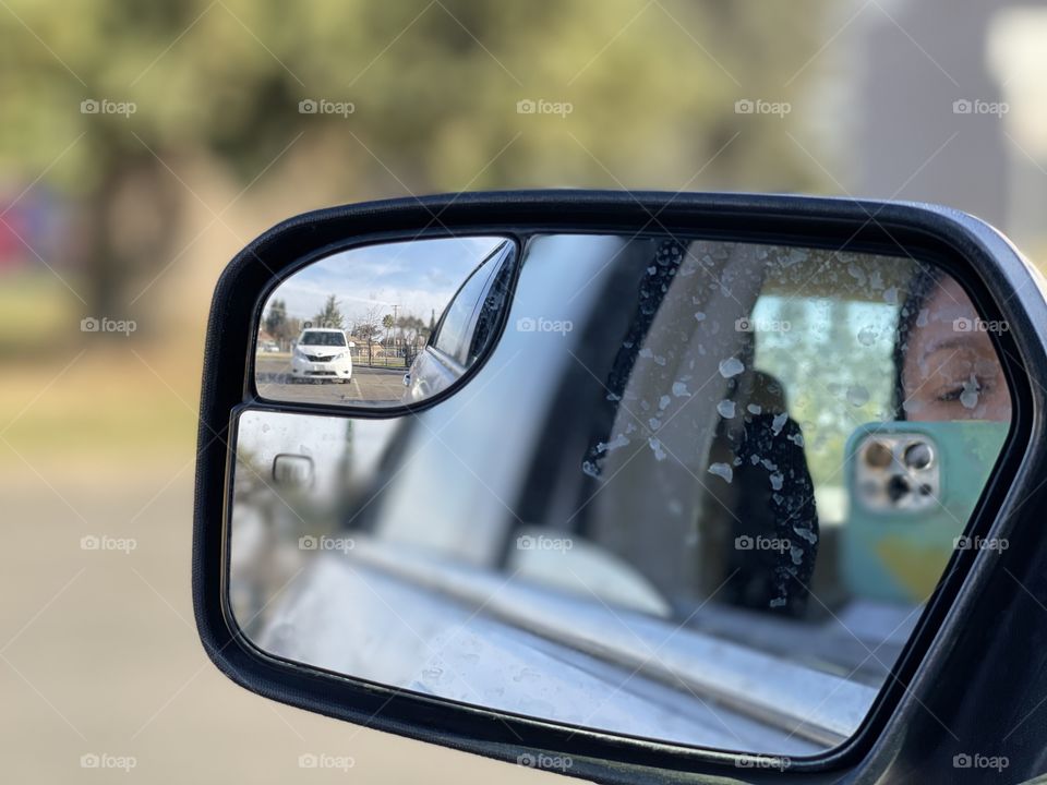 The side mirror for selfie in the parking lot of a beautiful winter season of California weather