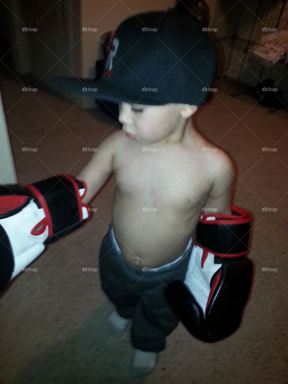 future boxer. my son trying on my gloves.