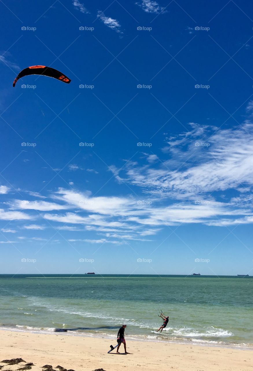 Kiteboarder skimming along the shoreline