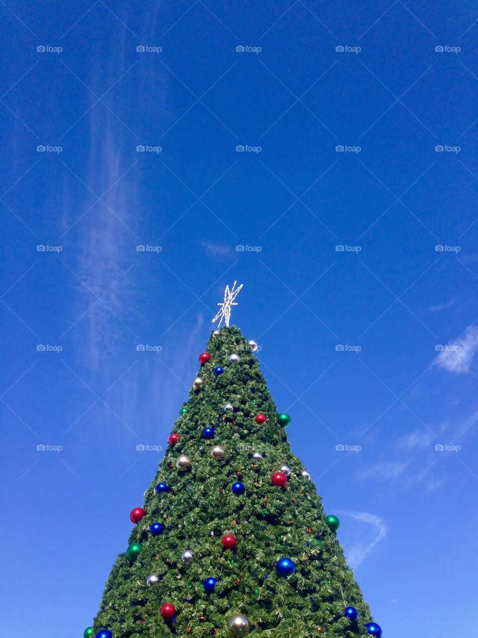 Christmas tree against a blue clear sky