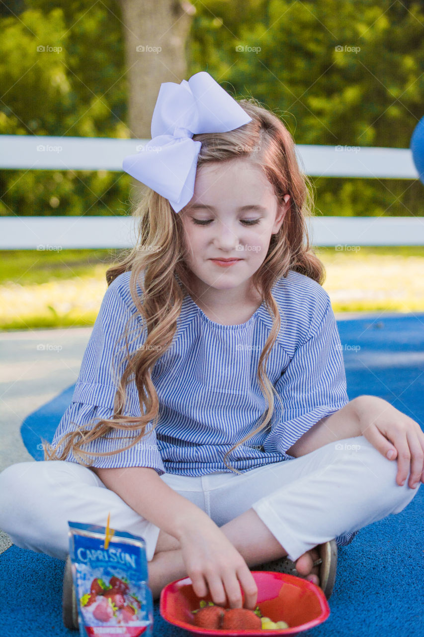 Young Girl Eating Fruit at the Park 2