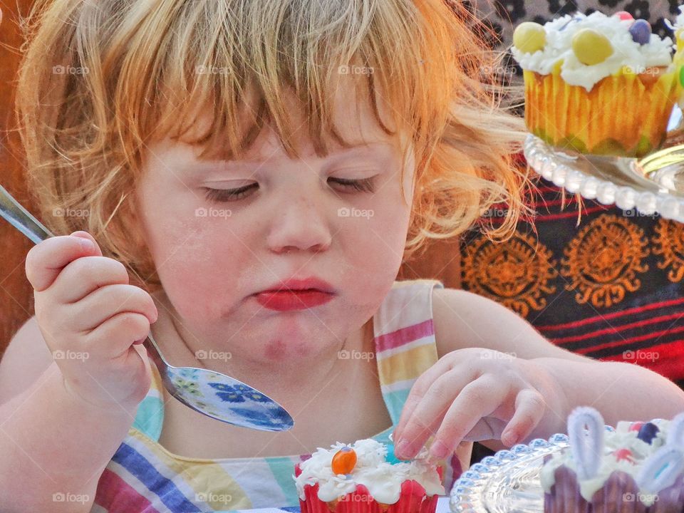 Girl With Cupcake. Redhead Young Girl Eating Colorful Birthday Cupcake
