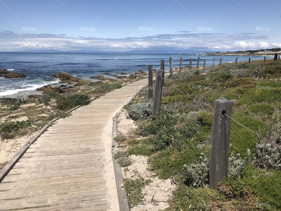 Talk a walk on the calmer side. Fence posts line a weathered boardwalk that runs down the length of the beach.