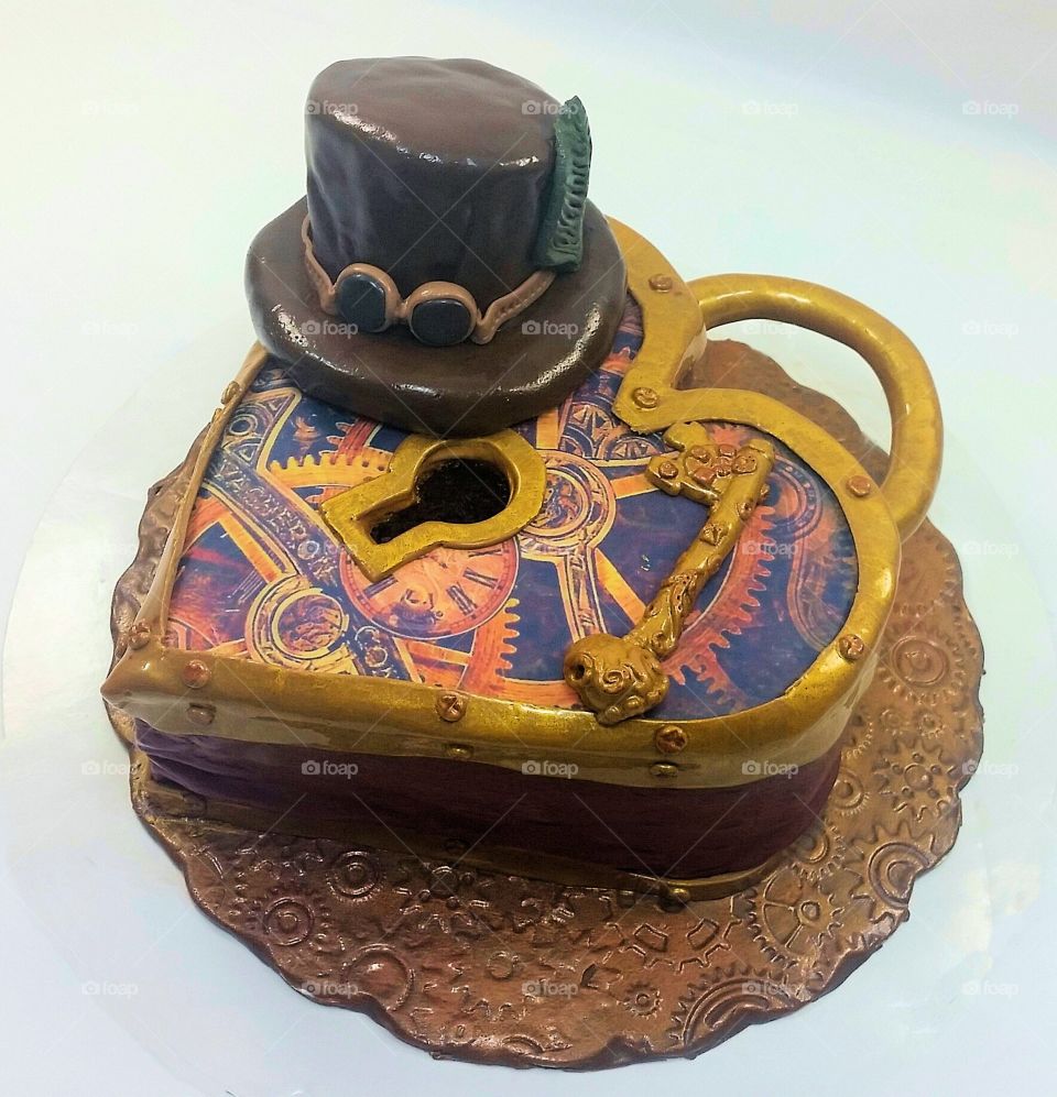 Steampunk valentine's day cake, heart shape lock with key, gears hat and skull.