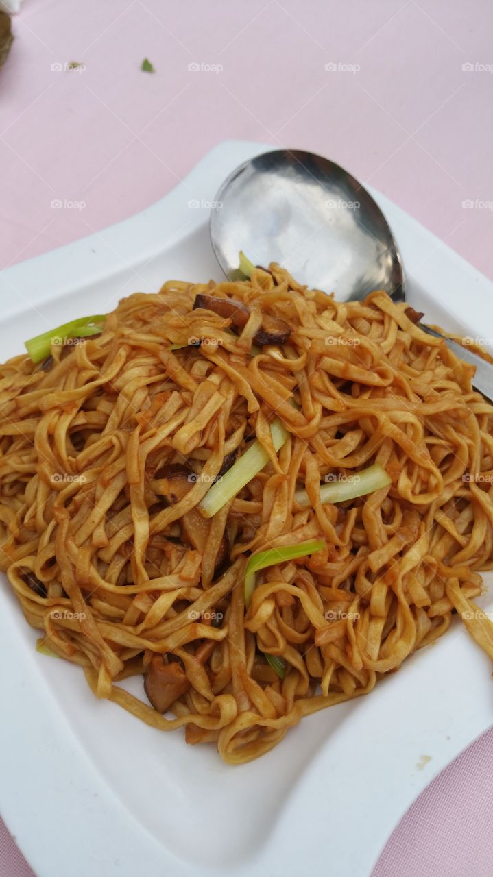 Delicious stir fried flat noodle with vegetable and mushroom, ready to be served