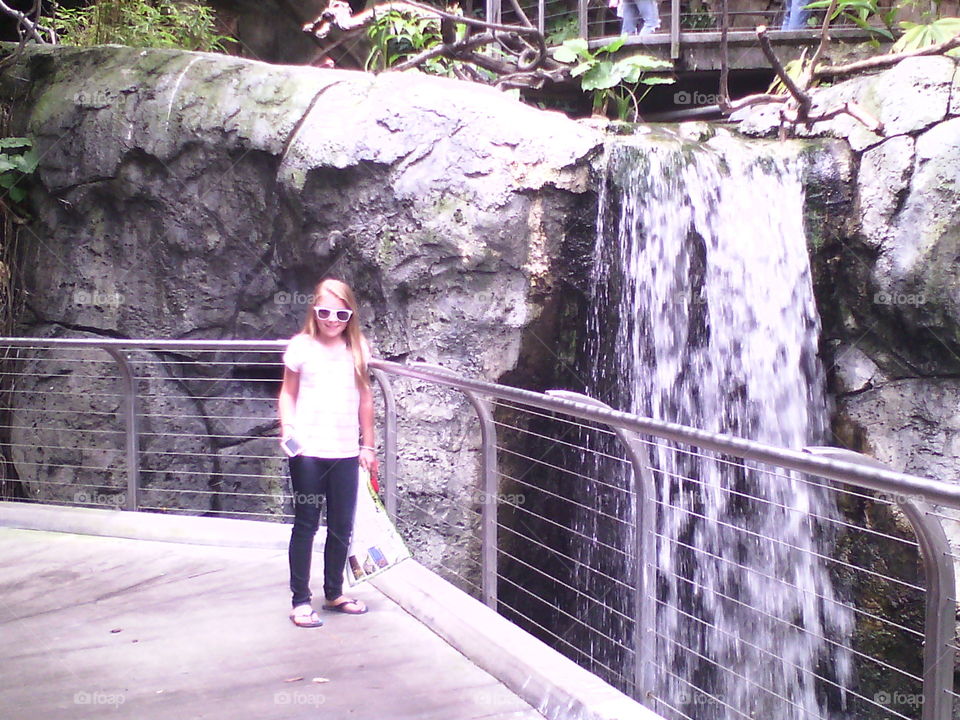 natural beauty. my daughter Taylor standing next to the waterfall at the San Diego zoo