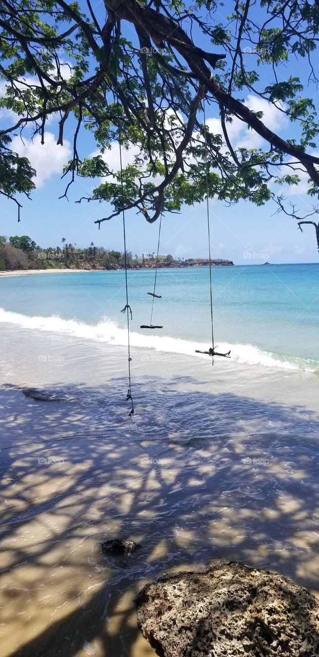 In the smaller of this twin island Nation of T&T we have a set of makeshift swings overlooking the water of this beautiful island... near Mount Irvin resort. Peace and serenity resides here.
