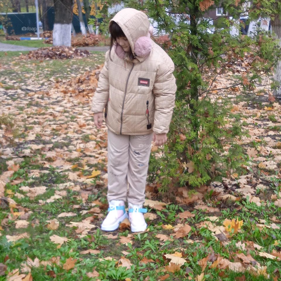 Nice girl in the autumn street.