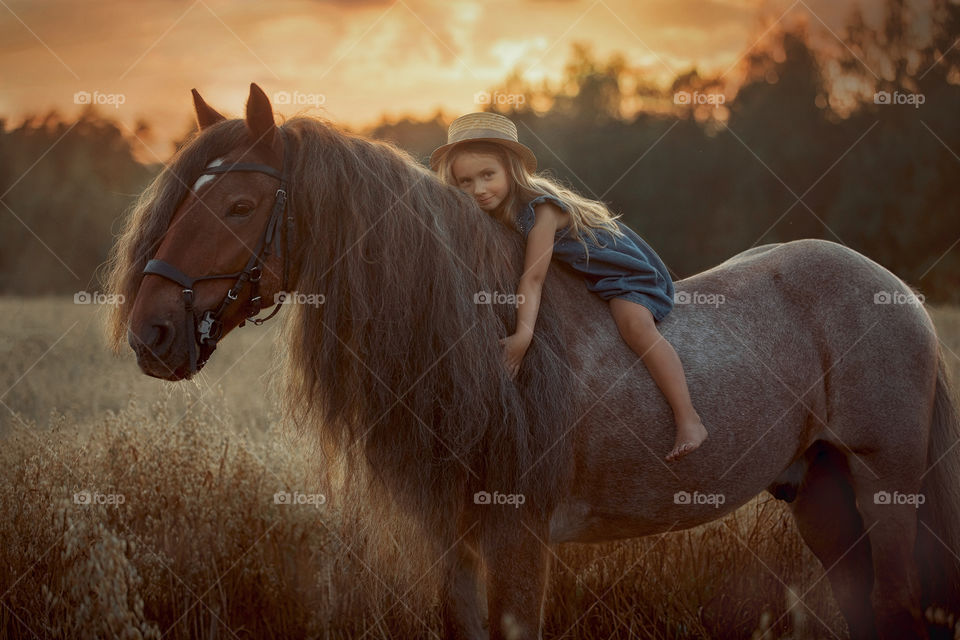 Portrait of little girl with tinker horse 