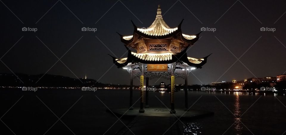 Chinese traditional wooden gazebo on the coast of West Lake  , public park in Hangzhou city,  China