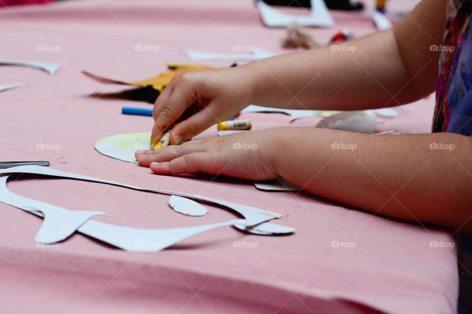 kid drawing with crayons