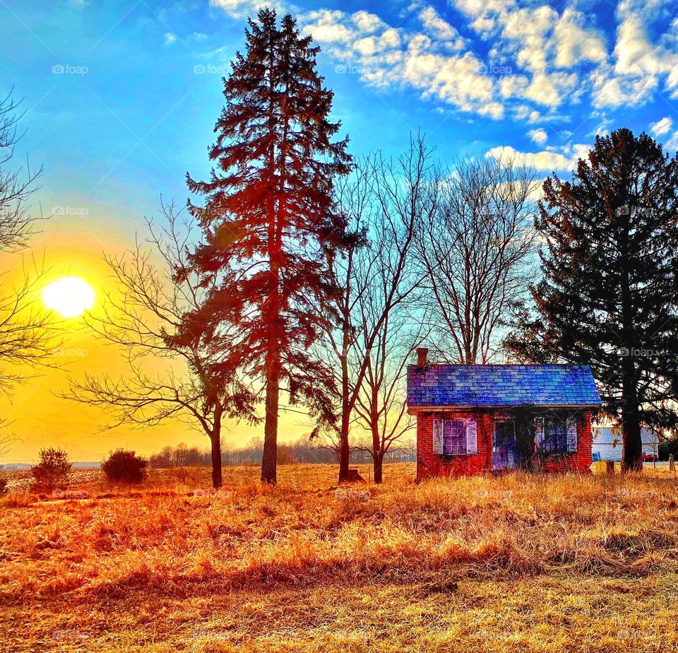 Sunset and a tiny old home in Indiana on a winter day 