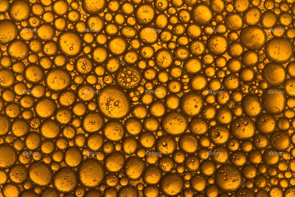 yellow oil bubbles macro shot