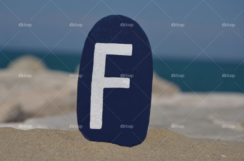 F,sixt letter of the alphabet on a colored stone